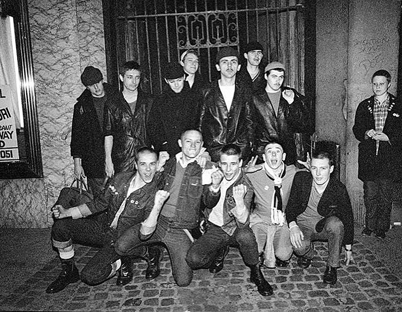 Dexy’s Midnight Runners with a group of local skinheads. Birmingham, 1980. Photo David Corio.

David”Taken from a shoot I did for <a href="/NME/">NME</a> in the bands hometown before their debut ‘Searching For The Young Soul Rebels’ was released. This group of skinheads suddenly joined the session”