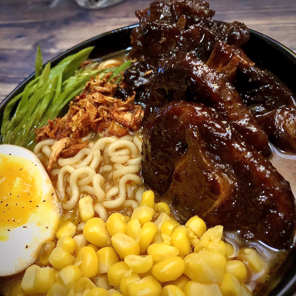 Oxtail Miso Ramen with kimchi flakes, Shoyu Tamago (soy egg), corn and scallions.