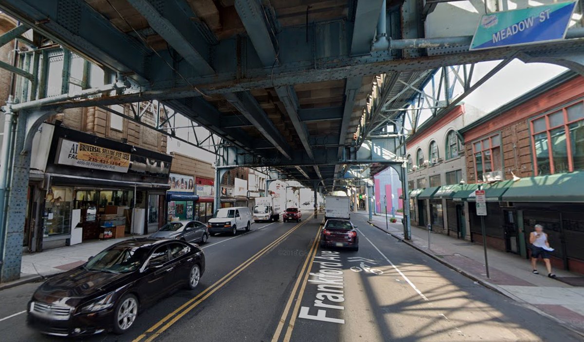 Philadelphia offers "the best examples in this country" of slowly widening streets through setback requirements and attrition, most famously at Chestnut  https://en.wikipedia.org/wiki/Chestnut_Street_(Philadelphia) and also Frankford Avenue