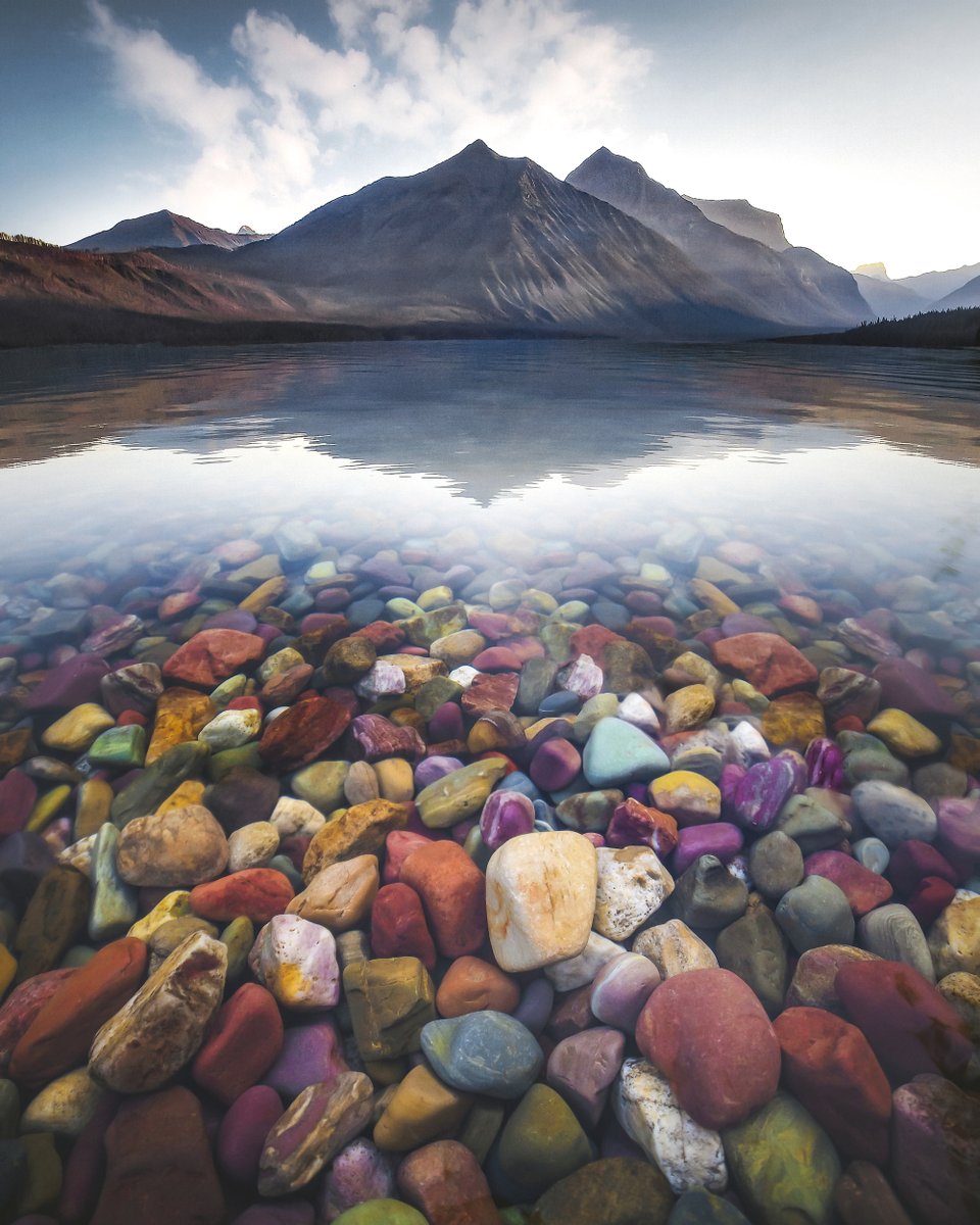 Interior's tweet photo. A virtual visit to any spot @GlacierNPS is visual candy, but there's something absolutely magical about Lake McDonald's vibrant rocks. Pic courtesy of David Rule #Montana #NationalParkWeek https://t.co/O1Z2I968LD