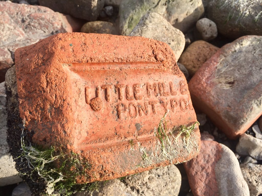 The beach is full of half-buried old bricks, stamped with the names of long-gone Welsh industrial ghosts.They spark thoughts of the life that used to team around the factories, docks, pubs & terraces which are now bland industrial units.