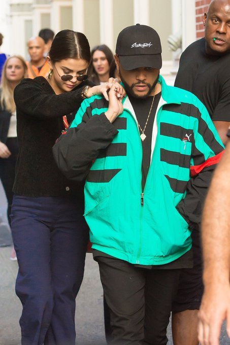 Abel Tesfaye and Selena Gomez holding hands (a thread)