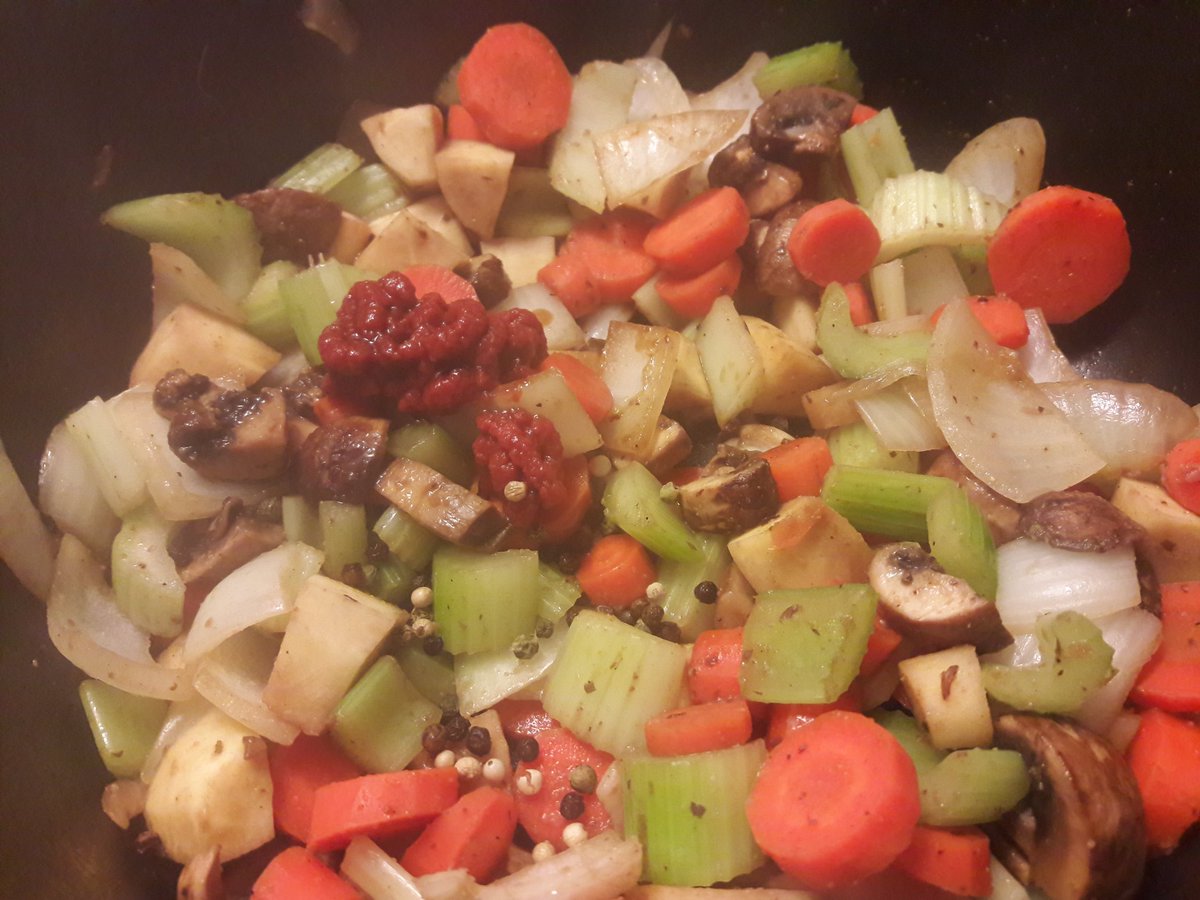 Browning the veggies, added some extra seasoning (tomato paste, Worcestershire sauce, whole peppercorns), added the chunks of browned beef back to the pot with red wine and beef stock, then topped with some butter, bay leaves and fresh rosemary and thyme. Ready for the oven!