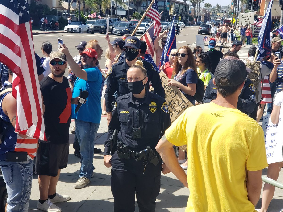 Officers asked the remaining protesters to disperse more directly, but some holdouts are undeterred. The officers, uninterested in an escalation, leave the corner containing the remaining protesters to patrol and observe from across the street.