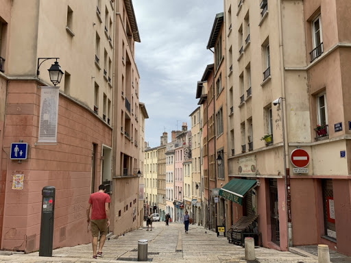 Form neighborhood work teams, pick designs from pre-selected pattern books and let the user/owners create their own homes, leaving space for small backyards, plazas, wells, towers, corner stores, etc. With rammed earth you can even build tall (Lyon) or distinguished (Kanazawa).