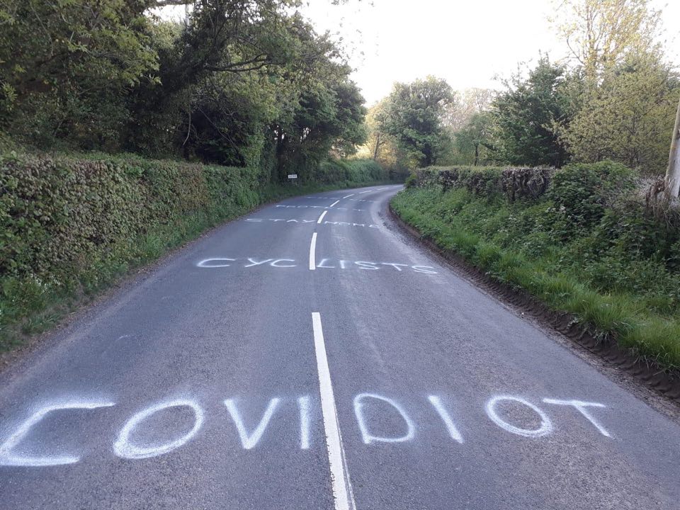roadcc's tweet photo. 'Covidiot cyclists stay at home protect the NHS' scrawled on road in Somerset: "Please be mindful that stirring up anti-cycling sentiment can encourage a small minority of idiots to go out and attack people", warns local cycling Club chairman. https://t.co/6y7uvyIBix #cycling https://t.co/NbmxUkgSf5
