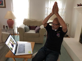 AccessJCA's tweet photo. Frank, a Kensington Club member, enjoys his gentle yoga exercises, one of many activities JCA's KC staff is providing during the pandemic. We are keeping up with our members through phone calls, videos and activity sheets. @MontgomeryCoMD @MoCoCouncilMD @EvanMGlass @Marc_Elrich https://t.co/jw0WVZQ1xR