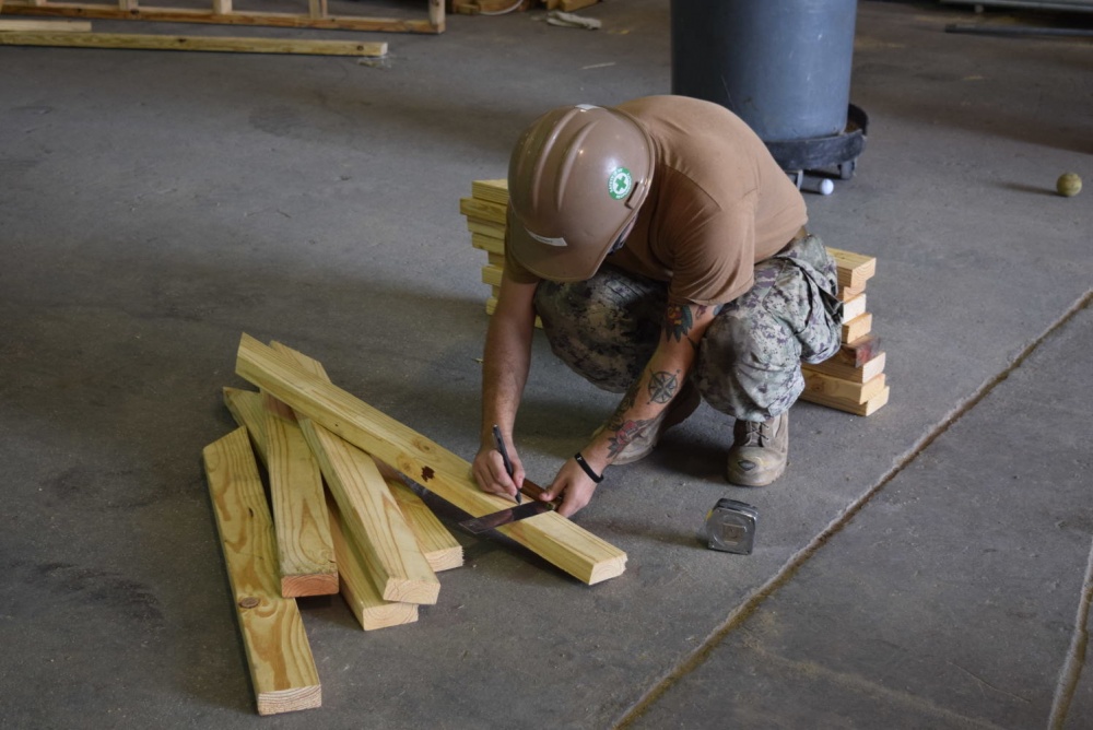 USPACOM's tweet photo. Seabees with Naval Mobile Construction Battalion #NMCB5 construct two pre-engineered buildings for Naval Beach Unit Seven #NBU7 to prevent the deterioration of their equipment and increase their lethality within the region. #ForgedByTheSea #FreeandOpenIndoPacific. https://t.co/ULbT03xX73