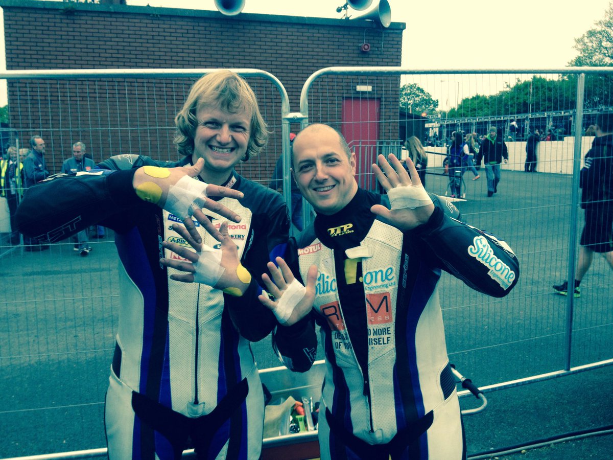 Scottphysio's tweet photo. Top tape job Tuesday😀. I love this retro shot from I think 2015 with ⁦@Lintinracing⁩ &amp; Russ Mountford showing off their anti-blister taping in TT Parc Ferme. The taping system devised by ⁦@clinicamobile⁩ has drastically reduced TT blisters.#saferriders #iomtt https://t.co/w2IzgQ8EB9