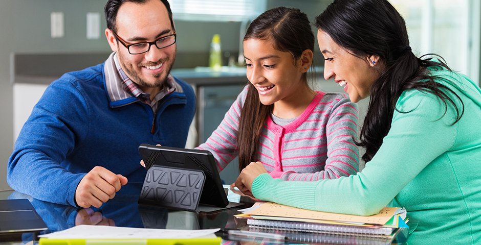 two adults with child using a tablet