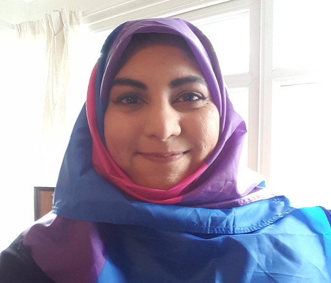 Selfie of Hafsa wearing the bi flag as a headscarf