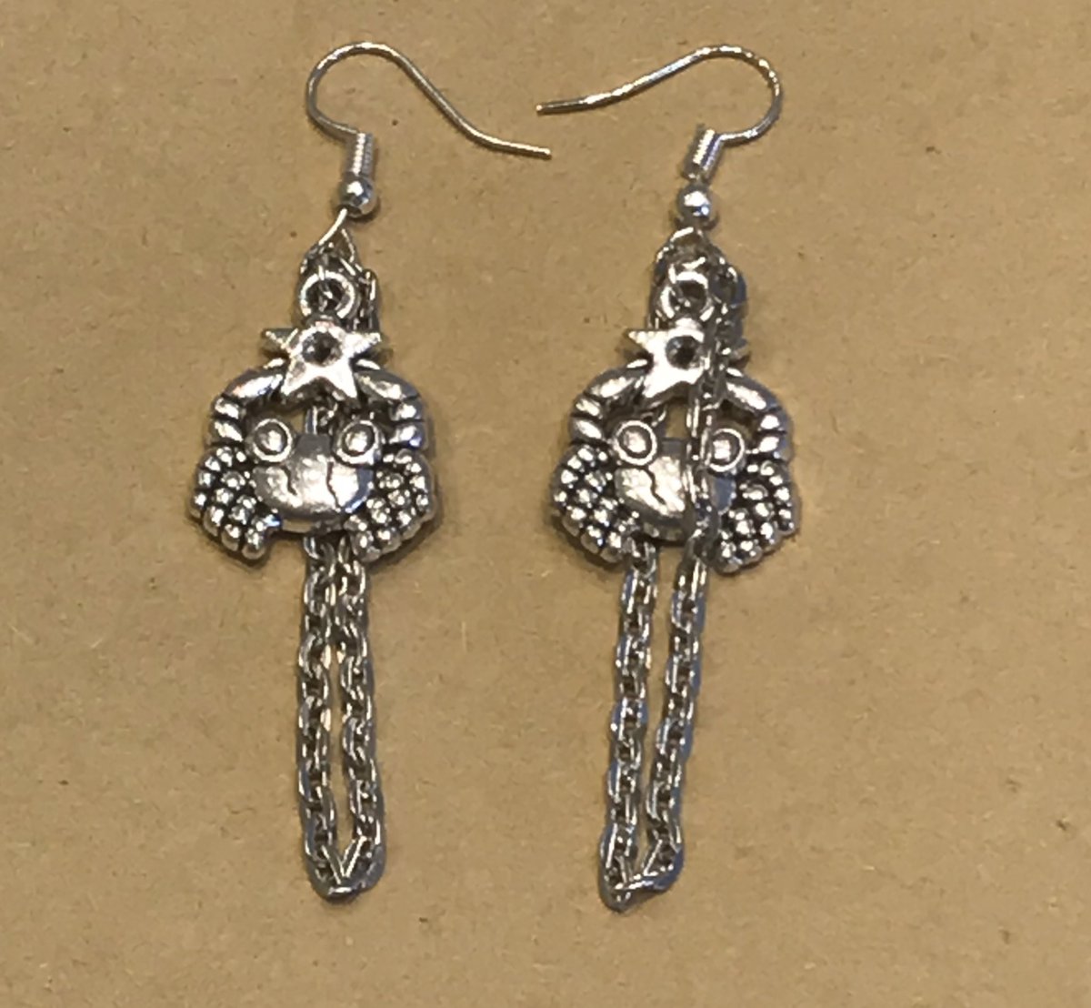 McOverreact's tweet photo. My earrings I’m making !! Resin £7.50, silver chains £6.50. ZODIAC THEMES ( minus snakes, I just like snakes lol) pls dm me !! If you could rt I’d be very grateful! 🥺💜 https://t.co/qymnqKzUo3