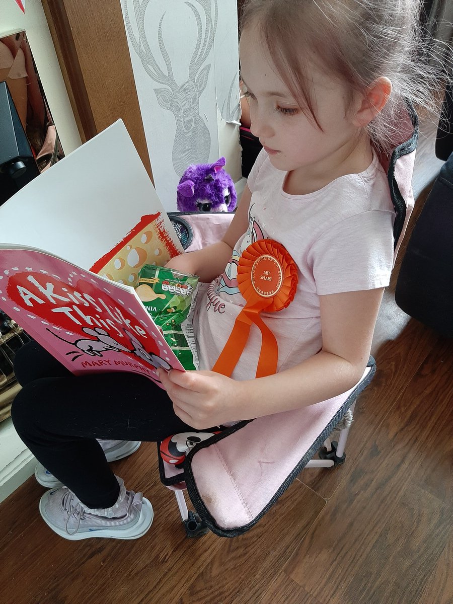 joanneaj39's tweet photo. @Class1C_ws @school_ws cleo with her rosette, sitting in a comfy spot reading her favourite book whilst eating a snack . At breakfast this morning she learnt about halves by cutting her toast and some beautiful hand writing for her OR spellings https://t.co/eDyzkRZwmS