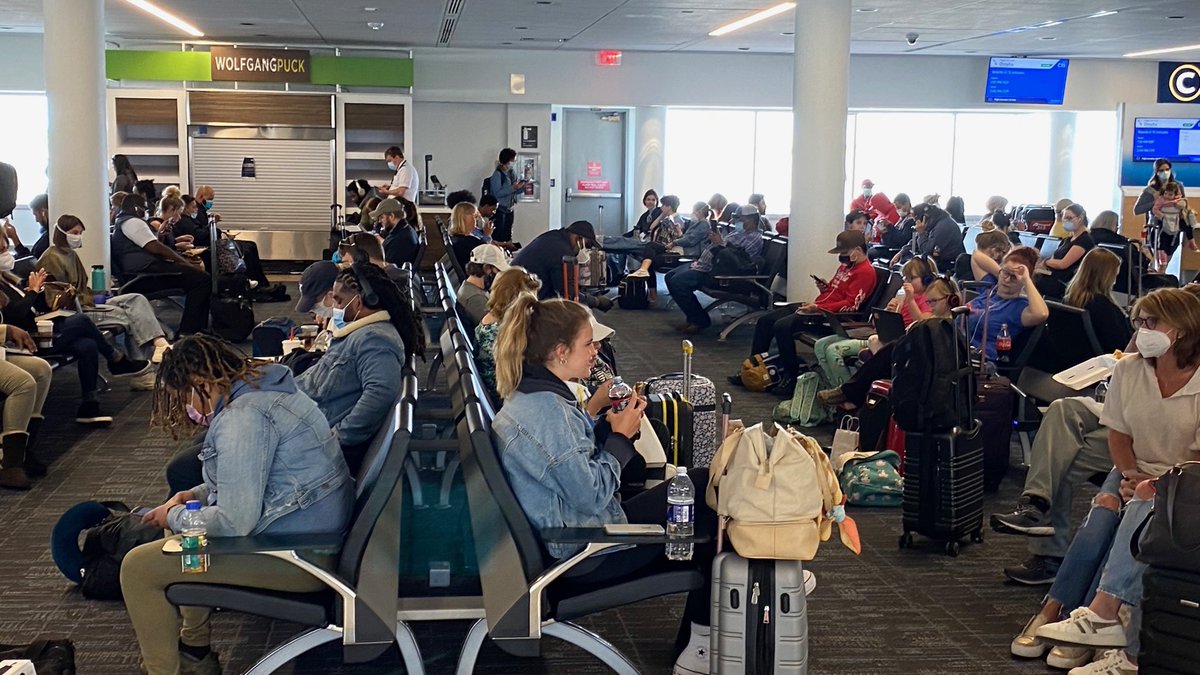 HughE_Dillon's tweet photo. These folks are waiting in American Airlines area in Charlotte for their plane to Philly. We’re doomed, might as well open. Some have masks, no one is socially distancing. https://t.co/uBsuqfDvGK