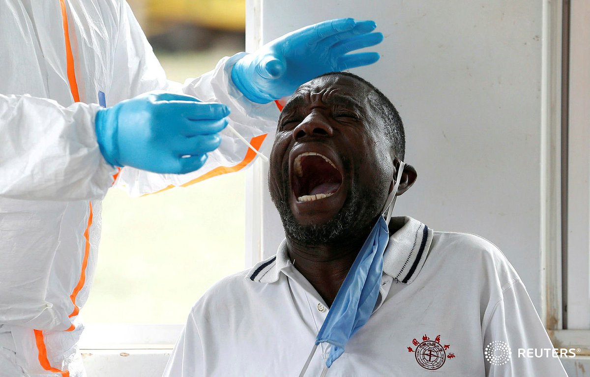 A Kenyan ministry of health medical worker takes a swab from a truck driver during a testing for the coronavirus disease (COVID-19), at the Namanga one stop border crossing point between Kenya and Tanzania, in Namanga, Kenya