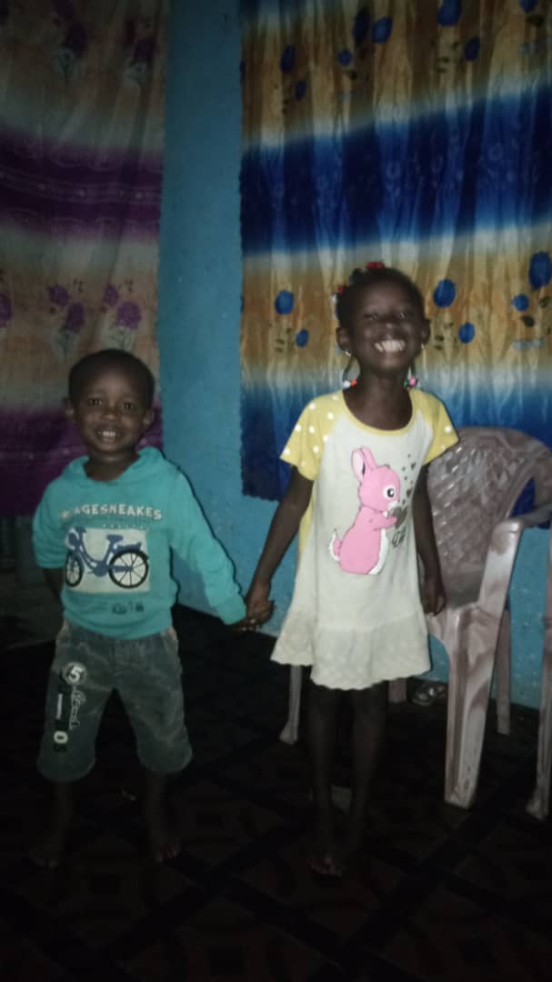 These are his two kids Achapan (on left) and Nachebe (on right) and his wife.