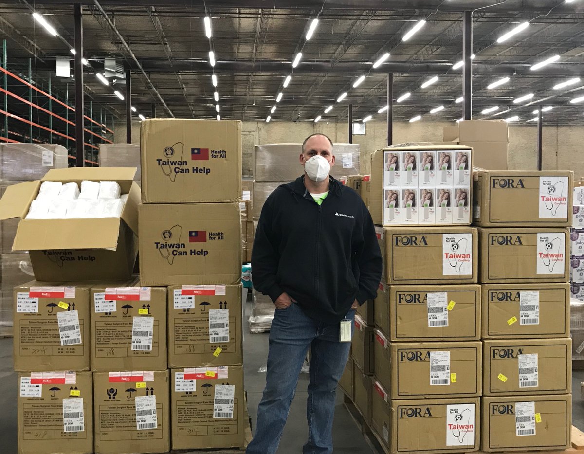 man standing in front of boxes of masks and thermometers