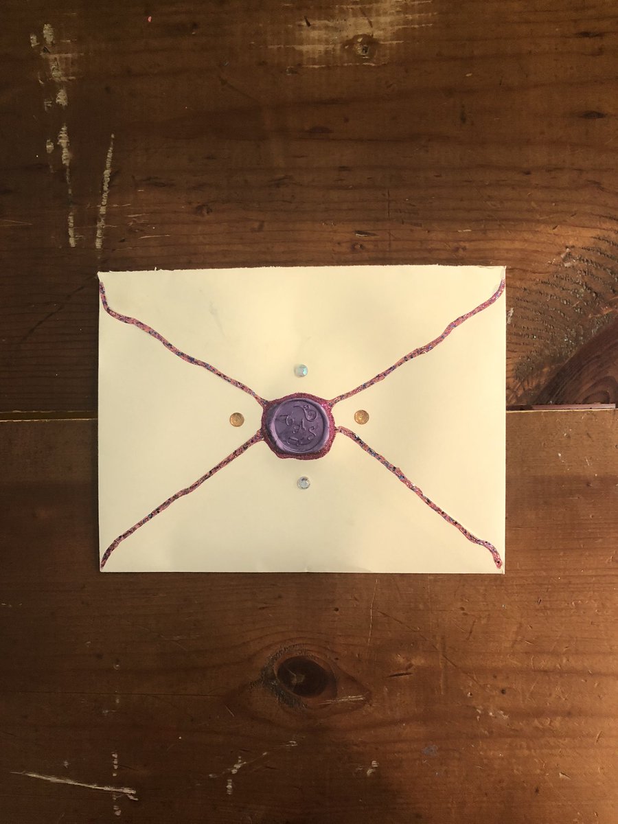 Inside the package was a simple envelope...Hand painted. With Gems. A wax seal - TAS. And, “Glitter glued with TSwift’s personal glitter glue,” according to Emerson.
