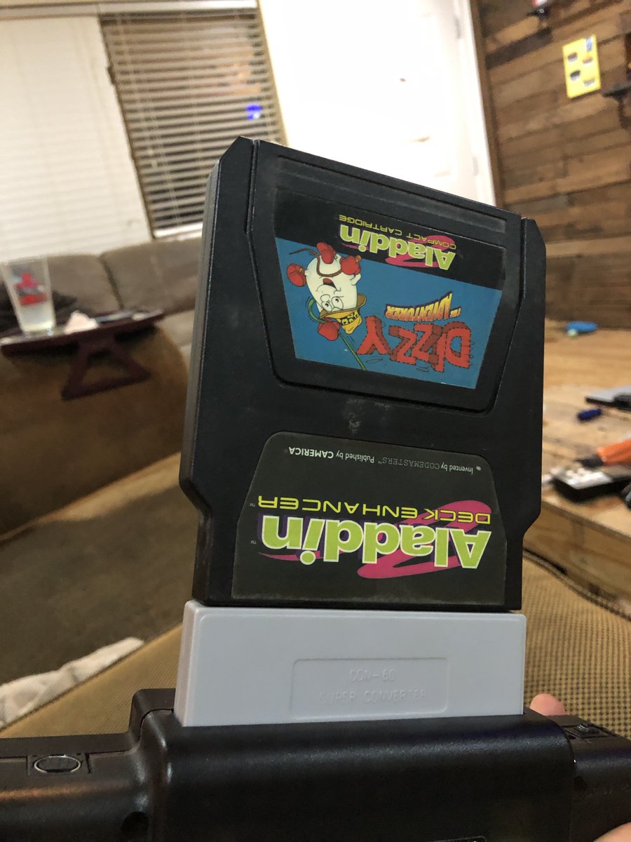 Here's me playing an unlicensed game (Dizzy) plugged into an unlicensed accessory (Aladdin Deck Enhancer), plugged into a handmade Famicom-NES adapter, plugged into an absolutely hacked together unlicensed portable Nintendo.