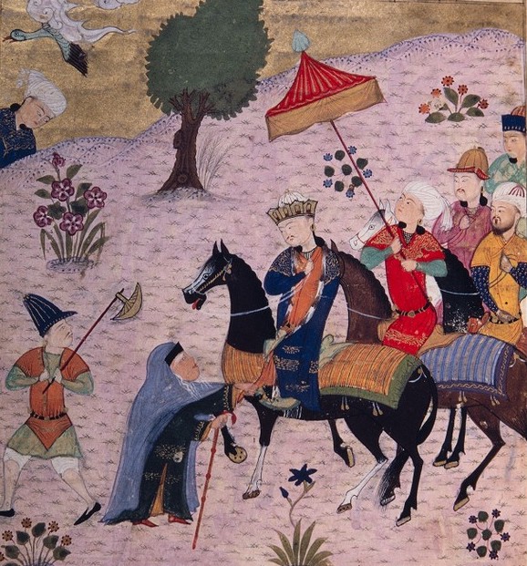 An old woman grabs Sultan Sanjar’s hem (دامن سنجر گرفت), pleading against his soldiers and threatening to reprimand Sanjar, if he does not help her, on روز شمار (Day of Reckoning, i.e. the Judgement Day). Here, hand on hem is also a metaphor for plea and threat.