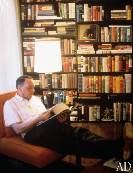Frank Sinatra, who was a voracious reader, sits in the 'Kennedy room' at his home in Palm Springs. This guest room, where the senator stayed for 2 days in 1960 during a campaign visit to California, was later converted into a library, with a plaque commemorating Kennedy’s visit.