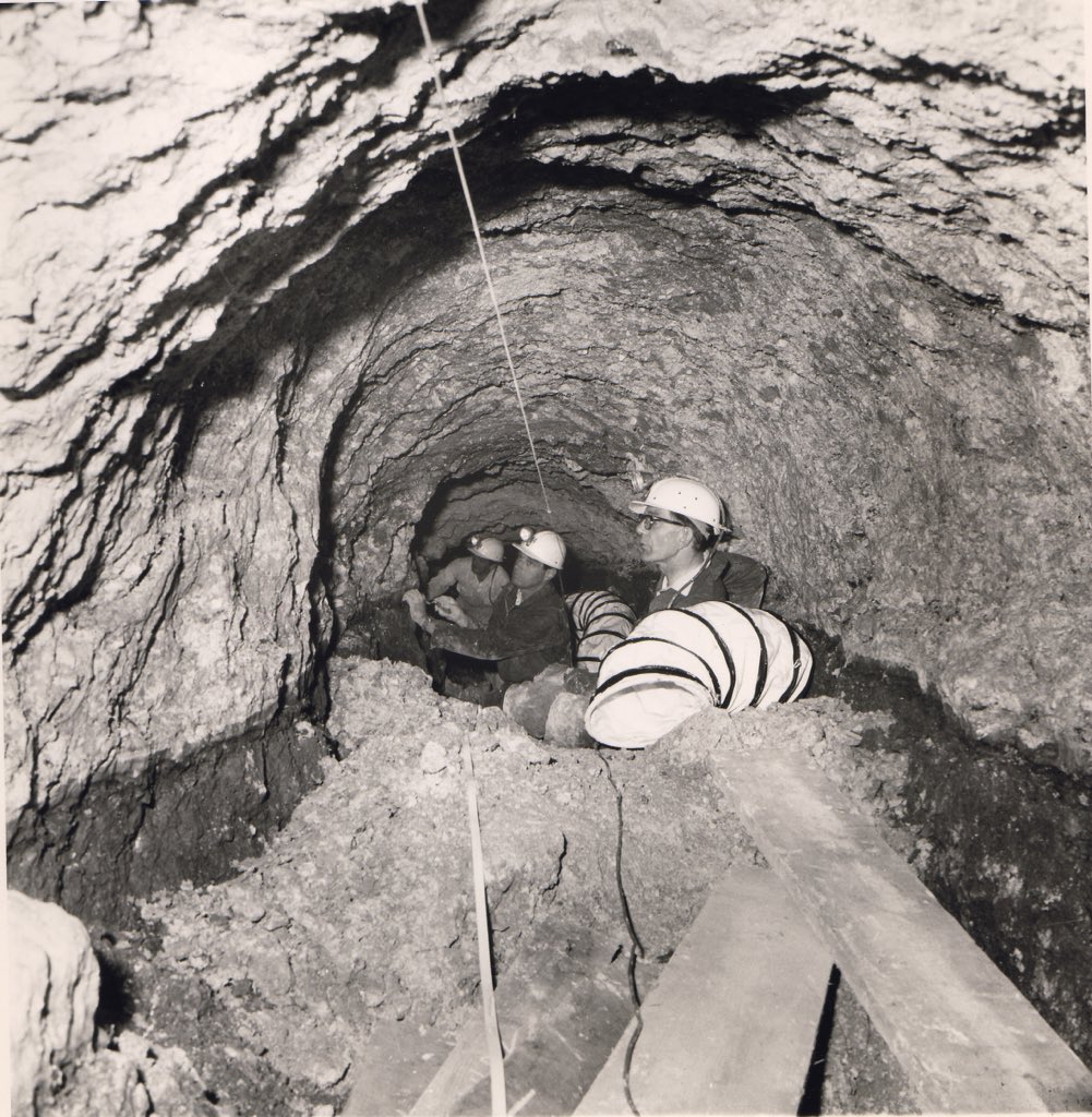 Photograph of Richard Atkinson peering into a void inside Silbury Hill in the 1960s.From the Alexander Keiller Museum archive.