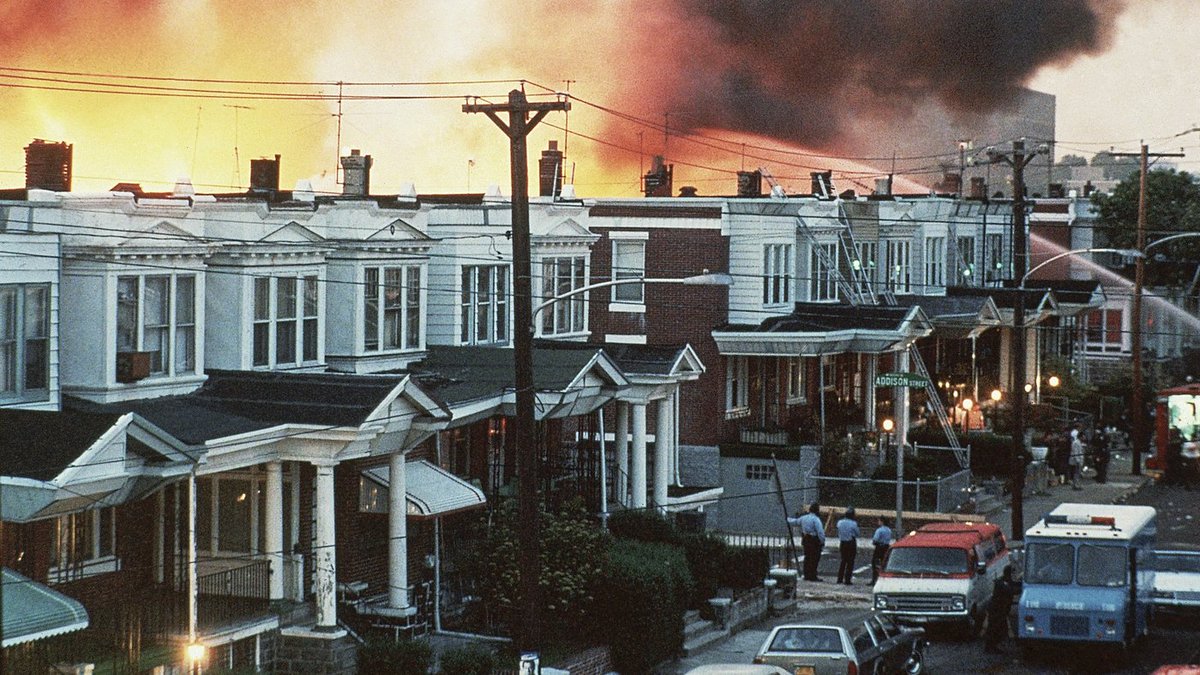 500 police officers shot 10,000 rounds of ammo at the house. The police commissioner then ordered to bomb the house, with a helicopter dropping a satchel bomb, typically used in combat, onto the roof. After detonation, they let the fire spread throughout the neighborhood.