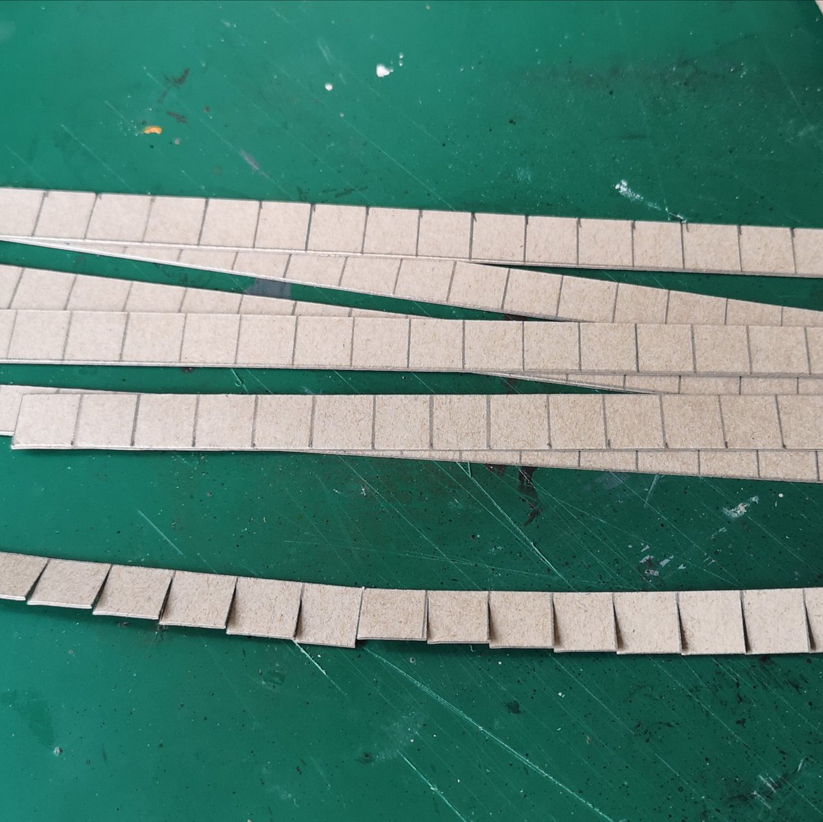 Right! Onto the roof tiles Queued all morning at the post office I made the tiles from thin card, drew a 1cm square grid & cut into strips then cut the line most of the way to make a line of tiles, then starting at the bottom I glued them to the roof. #warmongers  #ttrpg