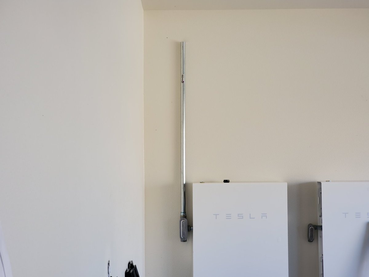 Conduit is making its way up the wall. We chose to have the powerwalls installed on opposite wall from power panel as it was wide open hence the need for conduit up and over to the other side.