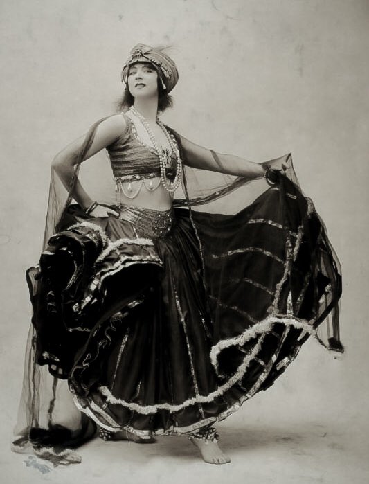 When Louise danced with Denishawn from 1922-1924, the touring company featured “exotic” dances from around the world including a nautch dance performed by the school’s co-founder Ruth St. Denis. A photo of Ruth (L) in costume and Louise later in an imitative pose for Richee (R).