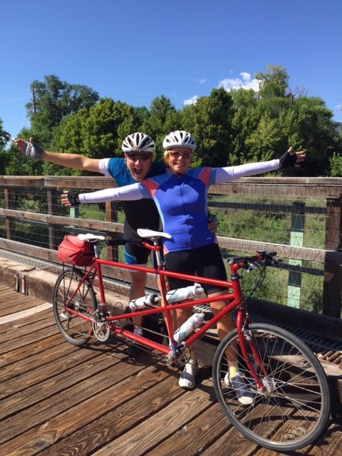 KMyers_Compass's tweet photo. Spending time with my family and friends keeps me happy and healthy, whether that time is virtual or in person.  Here is a picture of my husband and myself riding our family tandem in Colorado a few years ago.  #ChooseCompass, #CompassExperience #CharterSchoolsWeek, @CompassCs https://t.co/syiacqrxoa