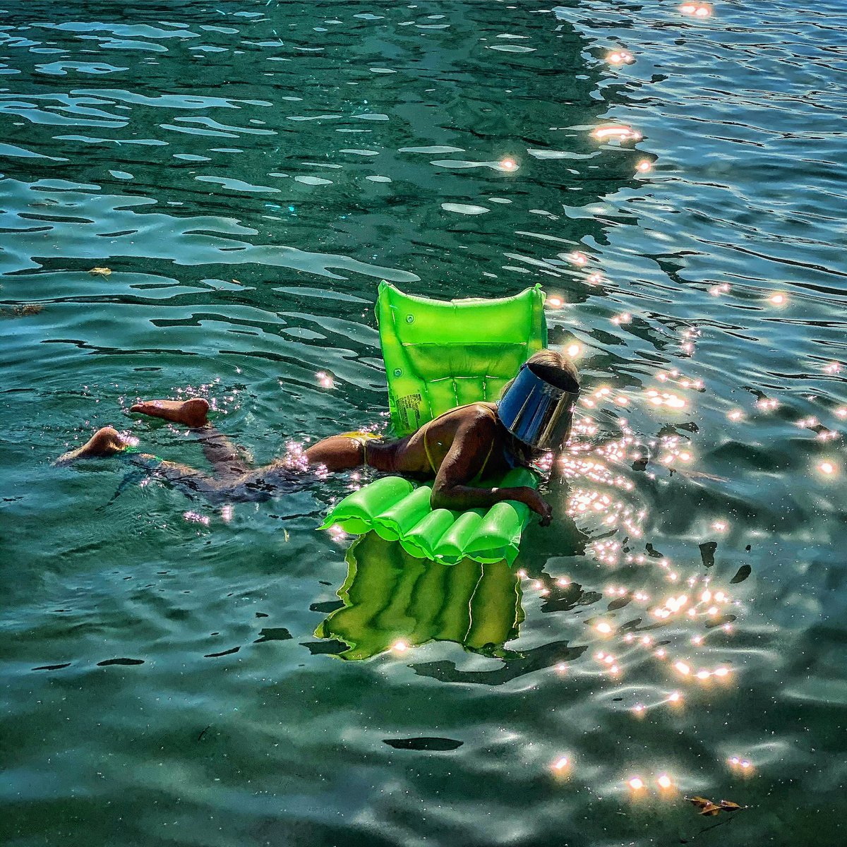 Chandanphoto's tweet photo. A woman wears a face shield amid fears over the spread of the novel coronavirus (COVID-19) as she swims in the #MiamiBay in #Miami #Florida #USA #UnitedStates #CoronaVirus #CoronaVirusUSA @AFPphoto https://t.co/BwIoB15m45