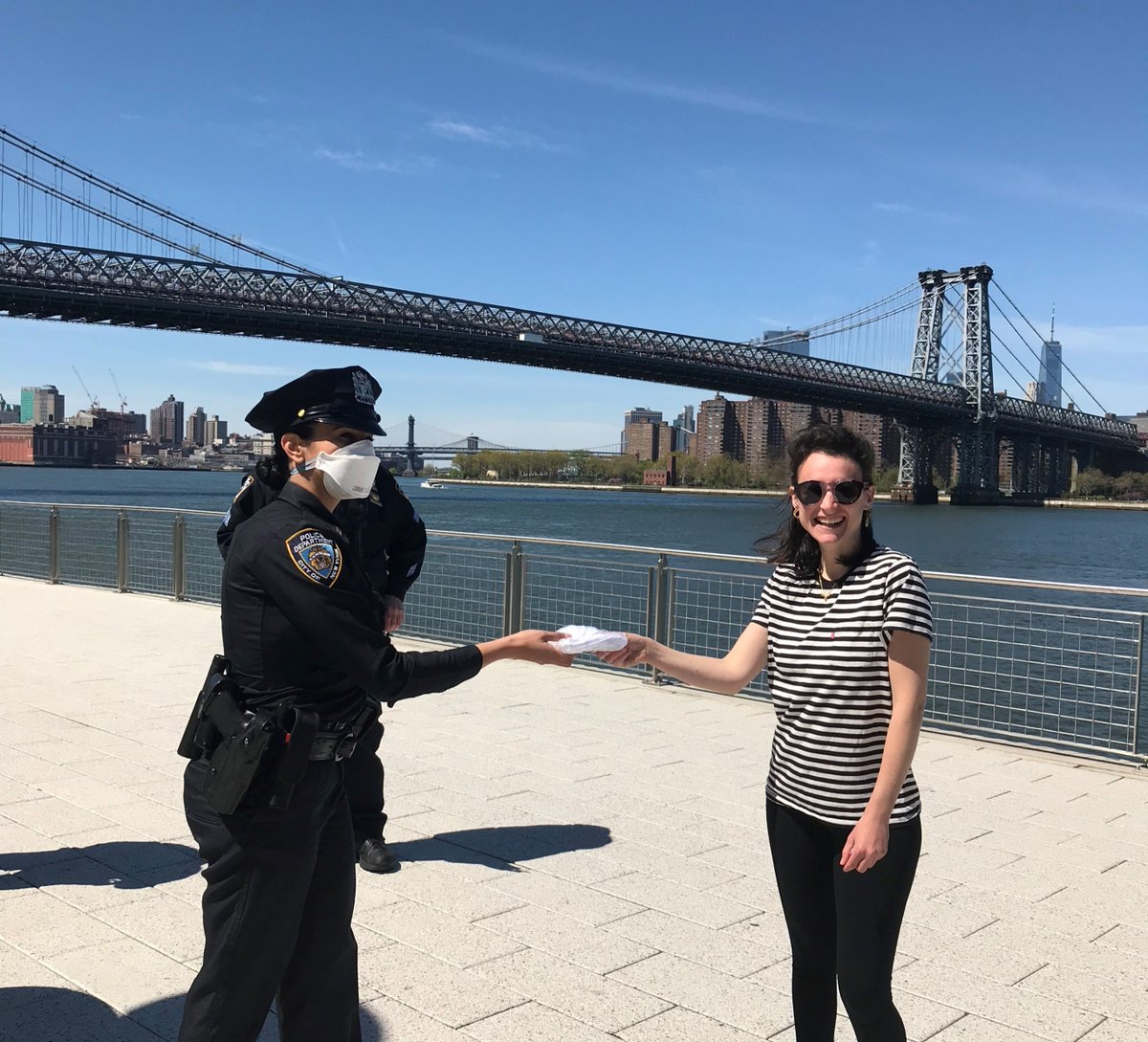NYPDnews's tweet photo. No mask? No problem.
This park-goer in Domino Park didn't have a mask, no problem, our task force officers were more than happy to provide her with one. https://t.co/qgSo1li2VH