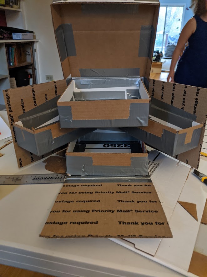 MTFleming's tweet photo. Cardboard mock up of a Weasley skiving snack box. I will make a wood one, but it may wait until I have table saw access once we can visit people. It will be an awesome craft tool box. I felt like I was channeling @donttrythis  working in cardboard and making a box. https://t.co/hwnu68Do29