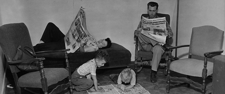 black and white photo of a family of four relaxing at home