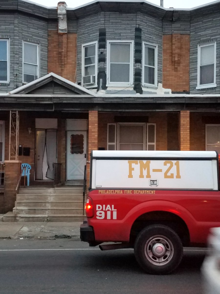 fire marshal's pickup truck parked in front of two-story rowhouse in daylight