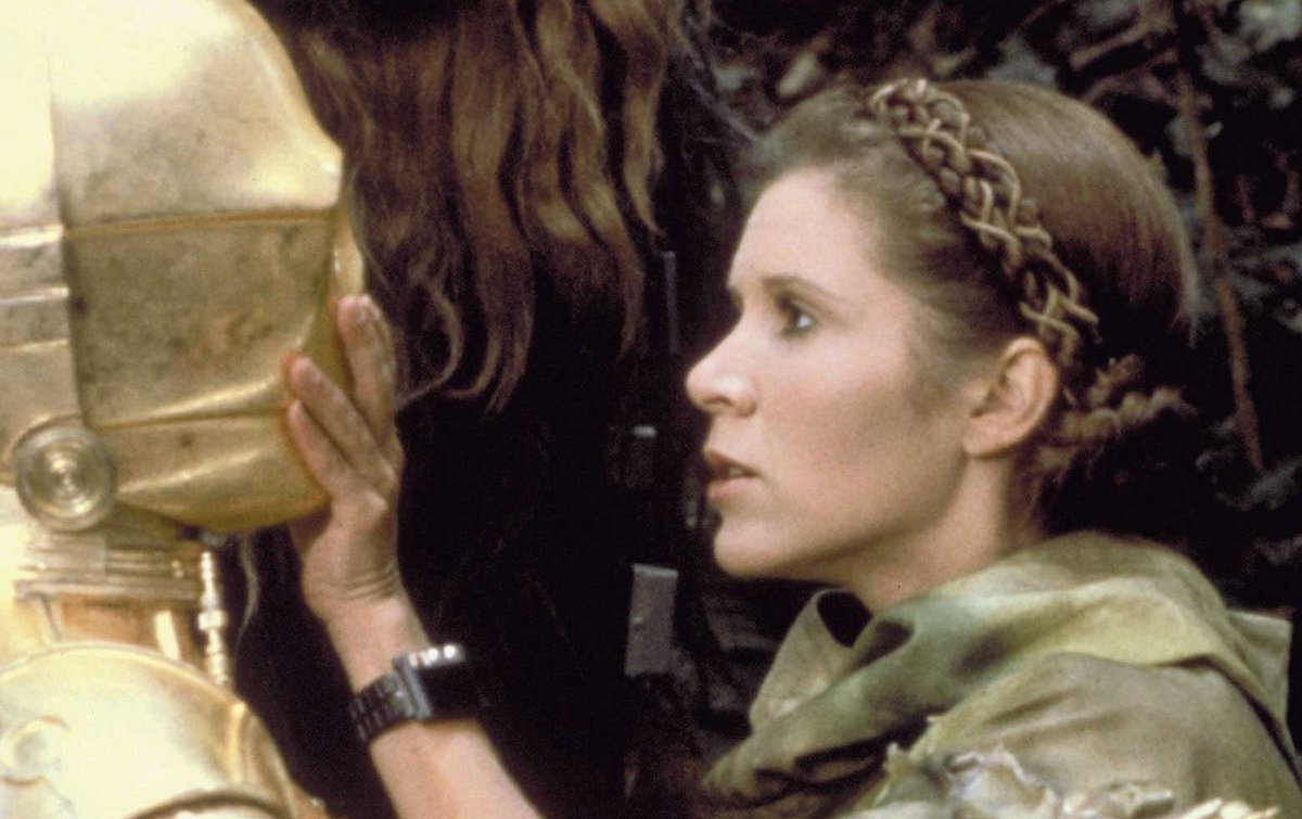 Princess Leia in Endor gear, with braids wrapped around her head and wound ...
