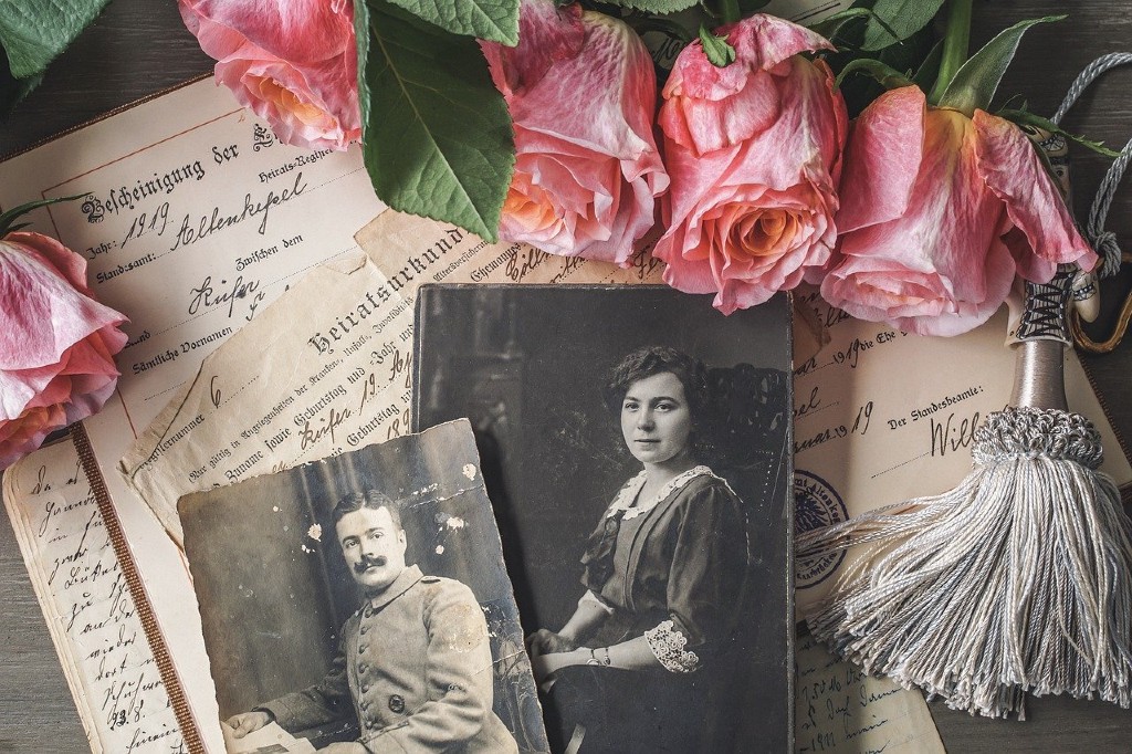 a vintage photo album with roses strewn around the edges