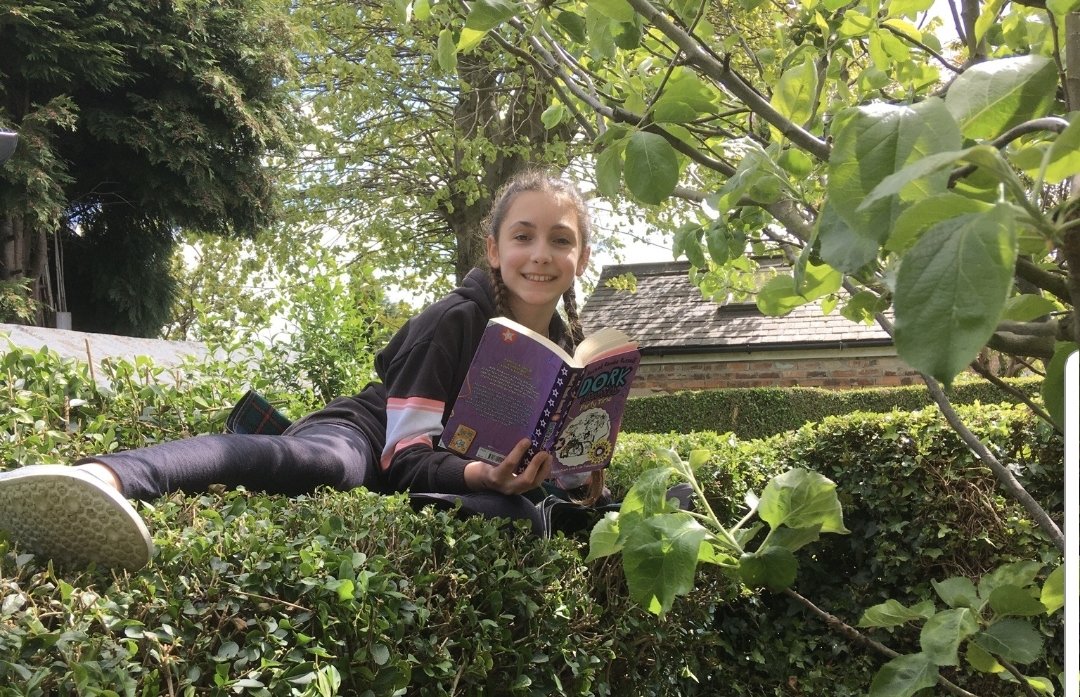 NottmPrimary's tweet photo. Here's Olivia from 6 Oak with her entry to the challenge. Yes that's her on a hedge and up a tree! #extremereader https://t.co/9aaBEbKTin