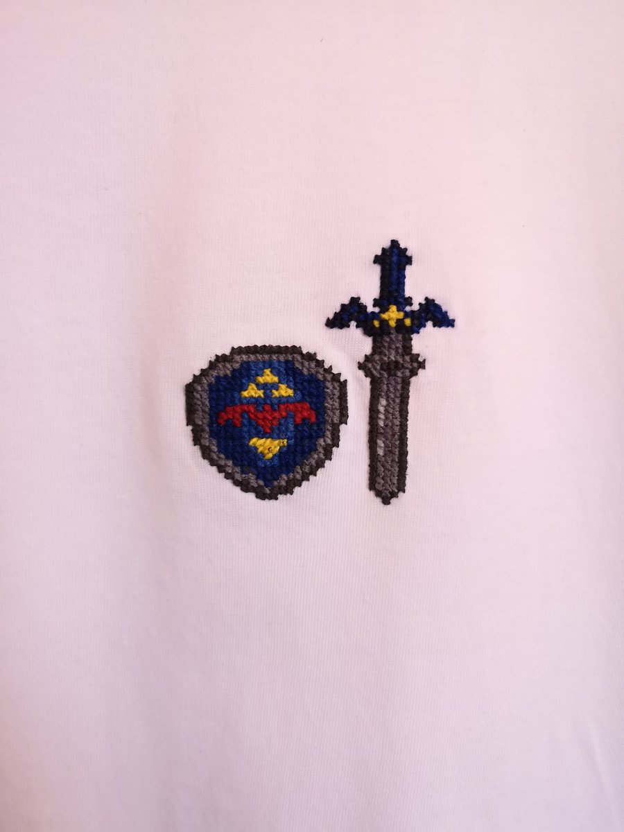 Will I ever remember this thread on time? T-shirt with master sword and hylian shield cross stitched into it!
