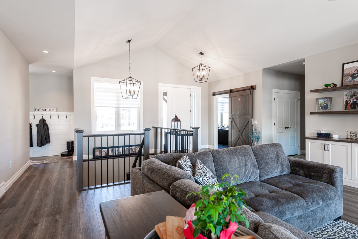 BickellBuilt's tweet photo. The "WOW' factor is in full force at this custom #BickellBuilt farmhouse. A few contributing factors: the soaring cathedral ceiling, the custom crafted barn door, the beautifully stained railing system, the beautiful tradition hanging light fixtures, just to name a few. https://t.co/6nCmwWK9zI