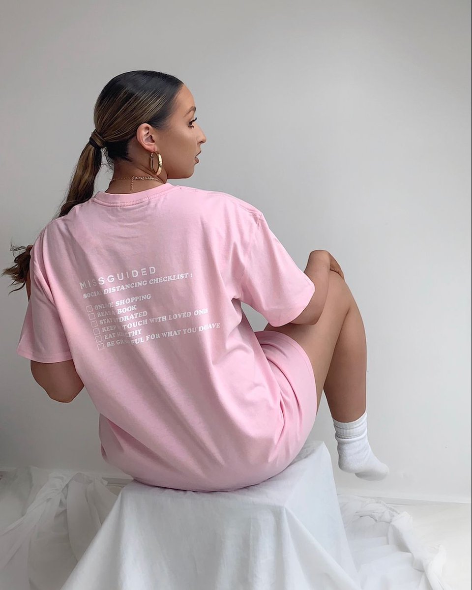Missguided's tweet photo. Your working from home uniform, sorted 
💘 Shop @bethrgillyy's 'pink social distancing checklist t shirt' (£18/$17) https://t.co/Wtjvt4HILT on site now 🛒 #babesofmissguided https://t.co/M0p3BmHgur