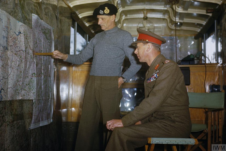 Even when the *KING* visited Monty in the field, he made no real effort with his rig => Field Marshal Sir Bernard Montgomery explains Allied strategy to King George VI in his command caravan in Holland, October 1944