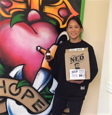 ConcernAust's tweet photo. NED Whisky has been helping to keep our young people safe with two donations of hand sanitiser – 360 bottles in total. #StepsOutreachService team member, Youth Worker Grace Baulch, is pictured with one of the boxes of sanitiser. #topshelfinternational #Homelessness #COVID19 https://t.co/vft1u4VSjB