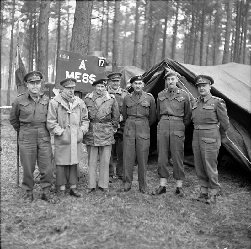 Monty and General Sir Miles Dempsey with the HQ staff after (iirc) the Battle of the Bulge - Dempsey is wearing a Royal Navy duffel coat and Monty is wearing whatever was clean that morning.