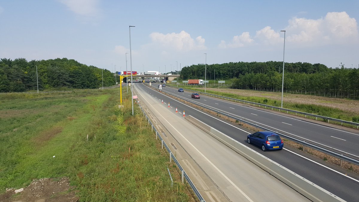 The photo below is from the BN25 location in June 2017 looking east - the A428 is on the right, the M11 overbridge in front (north is to the left - already stacked with traffic!) - the old 270-degree loop is visible on the far right with the red container lorry taking the turn 4/