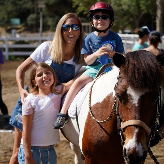 reinsprogram's tweet image. These are the smiles that we really hope we get to see this summer! One of our proud riders posing with family after completing their REINS Fun Day Horse Show class. Nothing beats these moments! #lovehorses #therapyhorse #horseshow #summerfun