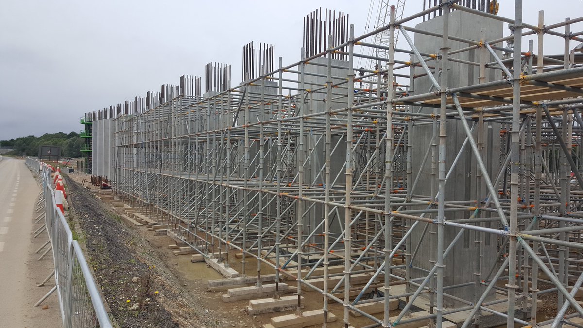 The falsework system is a proprietary type of scaffolding, with standards (vertical tubes) situated on timber sleepers, which sat on a specially-constructed stone mat - the tubes all clipped together and were adjustable to suit the falls of the bridge 19/