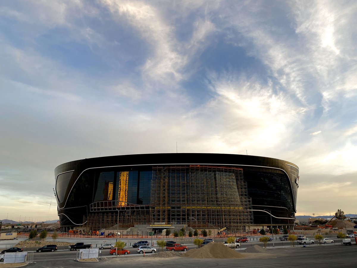 mickakers's tweet image. With the scaffolding gone on a portion of the lanai doors on Allegiant Stadium, the Mandalay Bay across I-15 reflects off the glass during sunset. #vegas #raiders #stadium