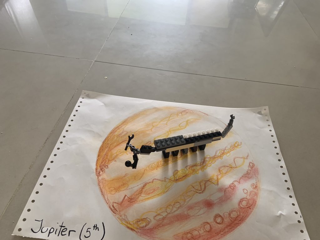 Europas jumping millipede, by my 8yr old! It has strong front arms to smash the ice. It can jump between Europa and Jupiter. It uses a claw on its tail for defence and moving ice #nhmlego